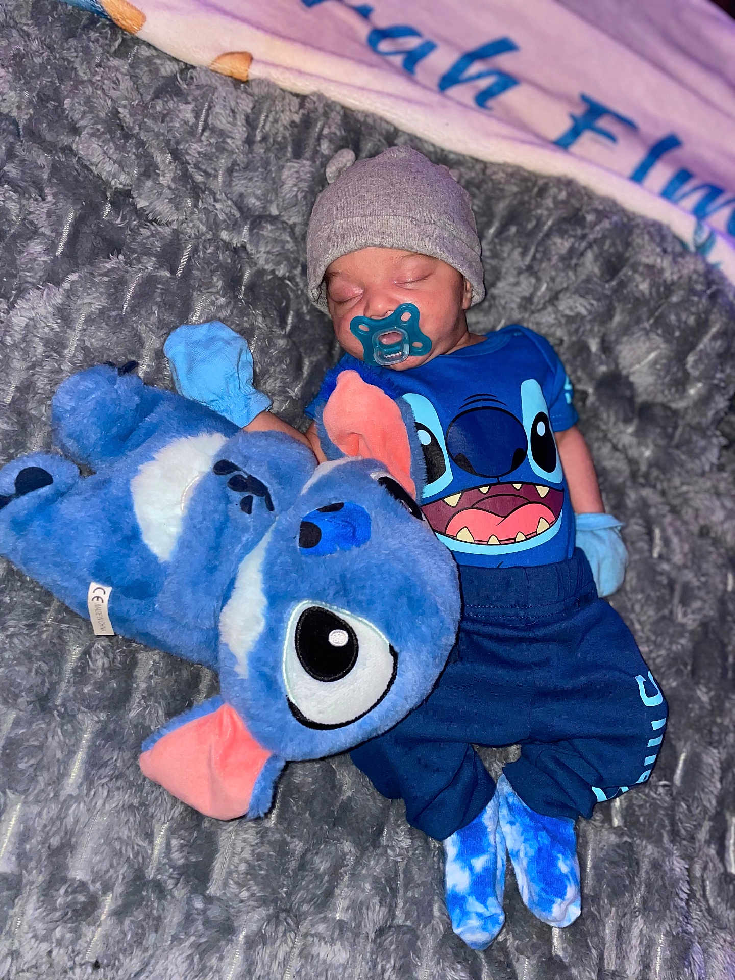 Jesrah joined the competition — help win amazing prizes! baby, blanket, blue_clothing, child, cozy, cuddling, cute, footwear, hat, indoor, mittens, pacifier, person, plush_toy, resting, sleeping, soft_texture, stuffed_animal, toddler, toy