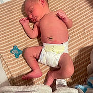 Jesrah is registered to the contest to win money with this photo: newborn, baby, sleeping, diaper, pacifier, blanket, striped_blanket, infant, skin, peaceful, lying_down, cozy, soft, cute, small, child, resting, indoors, human, toddler