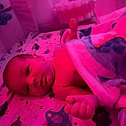 Jesrah joined the competition — help win amazing prizes! baby, infant, blanket, crib, pacifier, sleeping_area, soft_toys, bed, child, face, hand, cozy, nursery, lying_down, comfort, cute, indoors, resting, warm_lighting, toddler