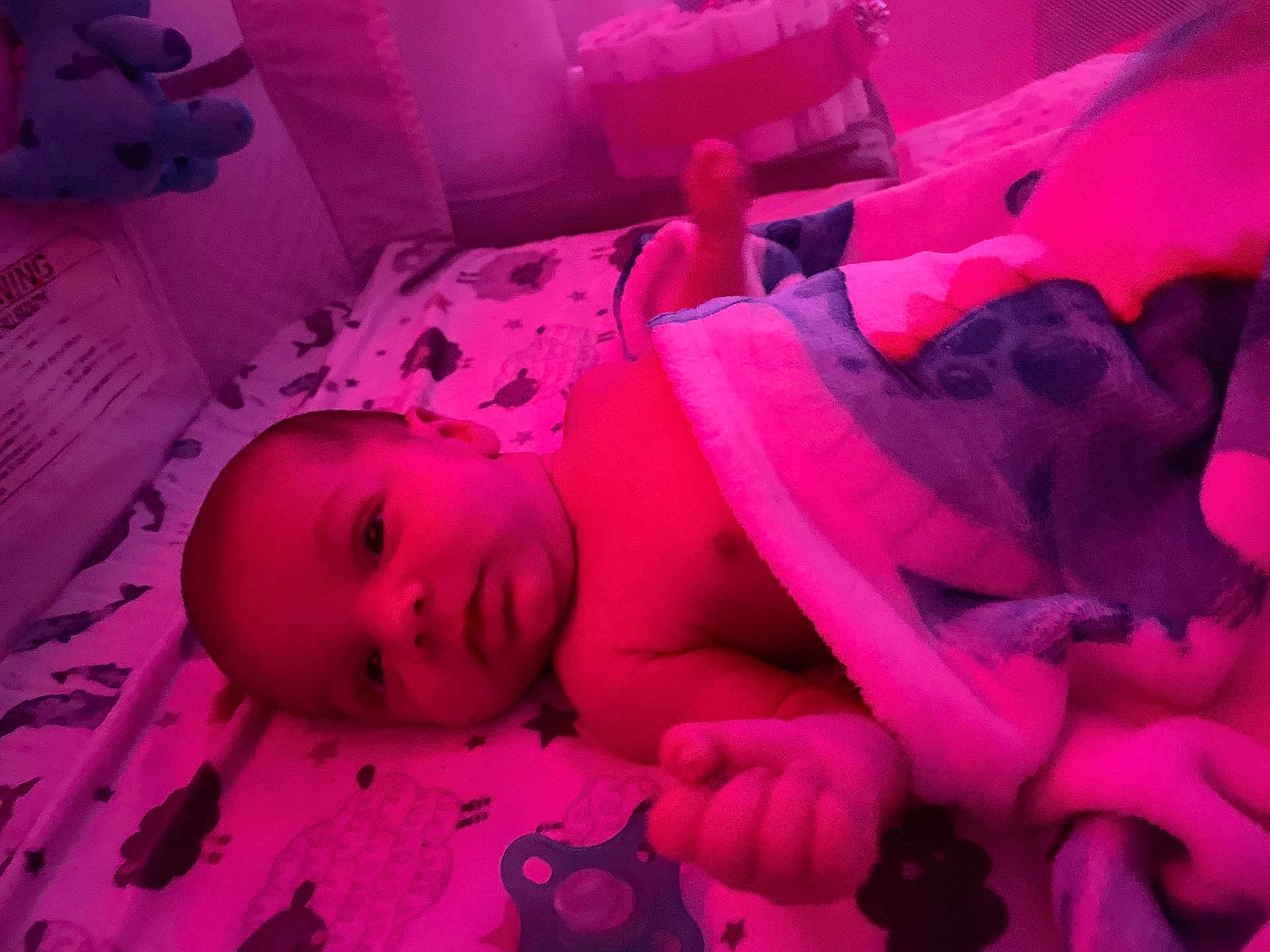 Jesrah joined the competition — help win amazing prizes! baby, infant, blanket, crib, pacifier, sleeping_area, soft_toys, bed, child, face, hand, cozy, nursery, lying_down, comfort, cute, indoors, resting, warm_lighting, toddler