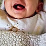 baby, smiling, blanket, closeup, face, infant, mouth_open, tongue, white_clothing, sun_embroidery, texture, cozy, happy, lying_down, head, skin, cute, child, portrait, indoors