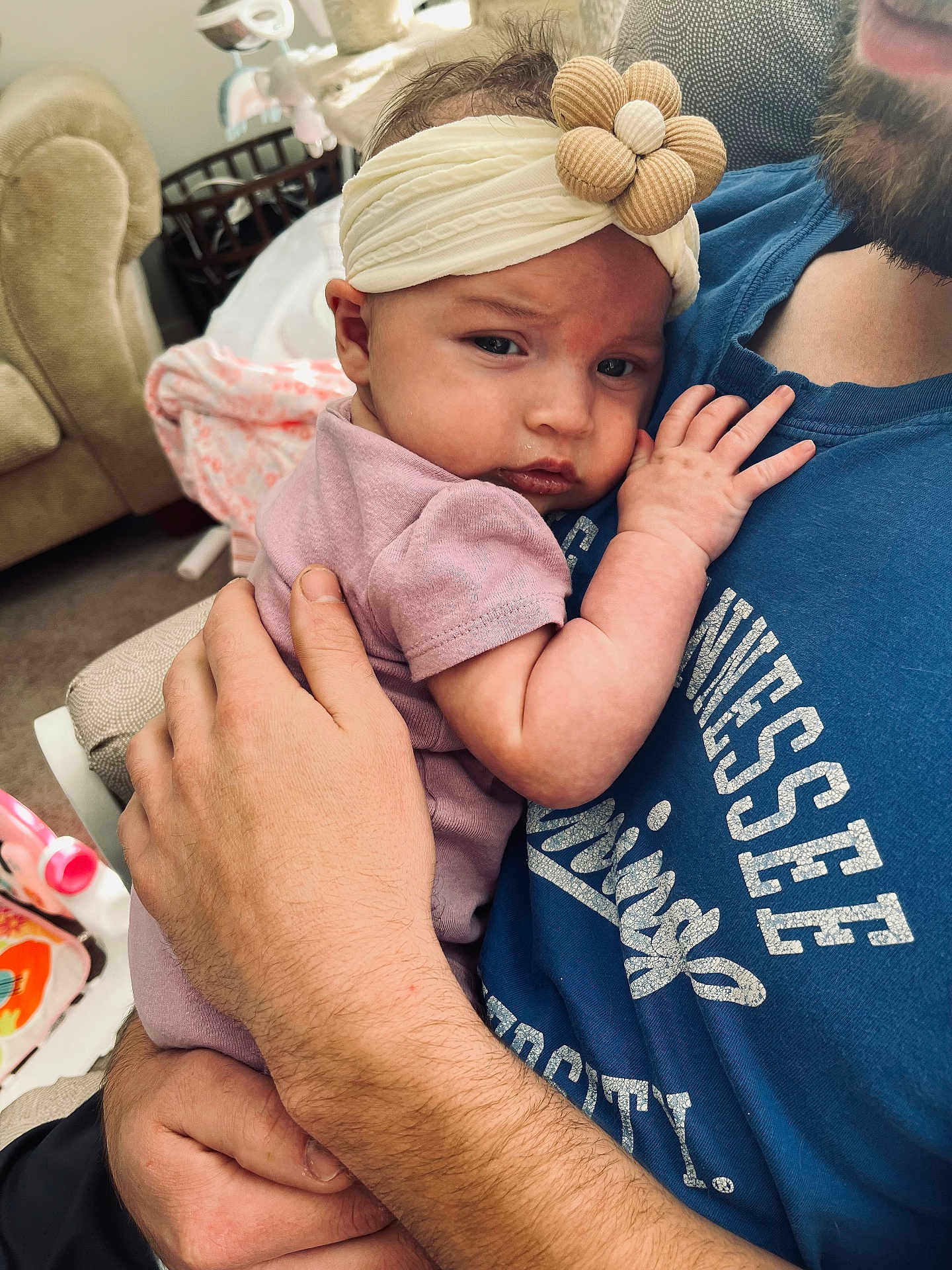 Lainey joined the competition — help win amazing prizes! baby, infant, headband, flower, child, adult, holding, cuddle, indoor, furniture, tshirt, hand, face, skin, clothing, person, parent, comfort, closeup, soft_lighting