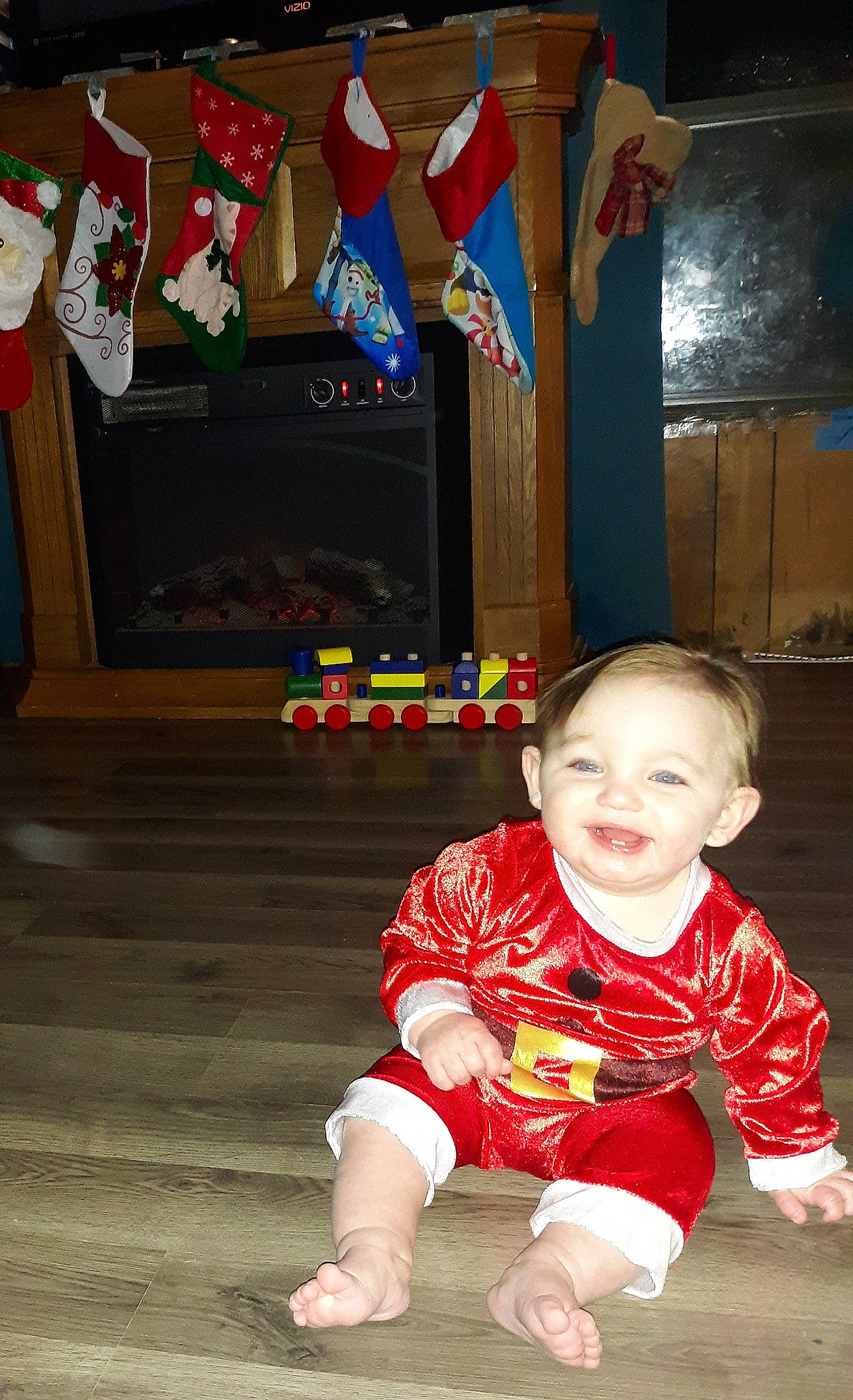 Kaine is registered to the contest to win money with this photo: ankle, baby, baby_crawling, baby_toddler_clothing, barefoot, carmine, cheek, child, christmas_stocking, crawling, floor, flooring, foot, human, joy, person, play, sitting, sock, toddler