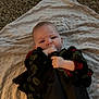 Tilly-May is registered to the contest to win money with this photo: baby, blanket, carpet, child, clothing, cute, expression, face, floral_pattern, hand, indoor, infant, lying_down, person, skin, sleeves, small_toy, texture, toy, white_pants