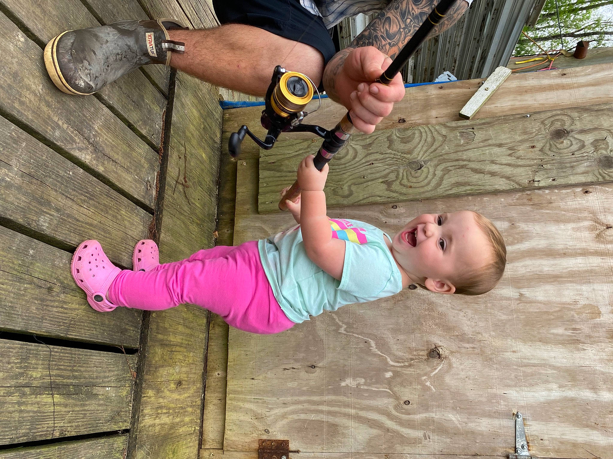 Haislee is registered to the contest to win money with this photo: baby, baby_toddler_clothing, child, flooring, foot, fun, grass, happy, human_leg, leisure, person, play, recreation, shorts, sitting, sneakers, thigh, thumb, toddler, tree