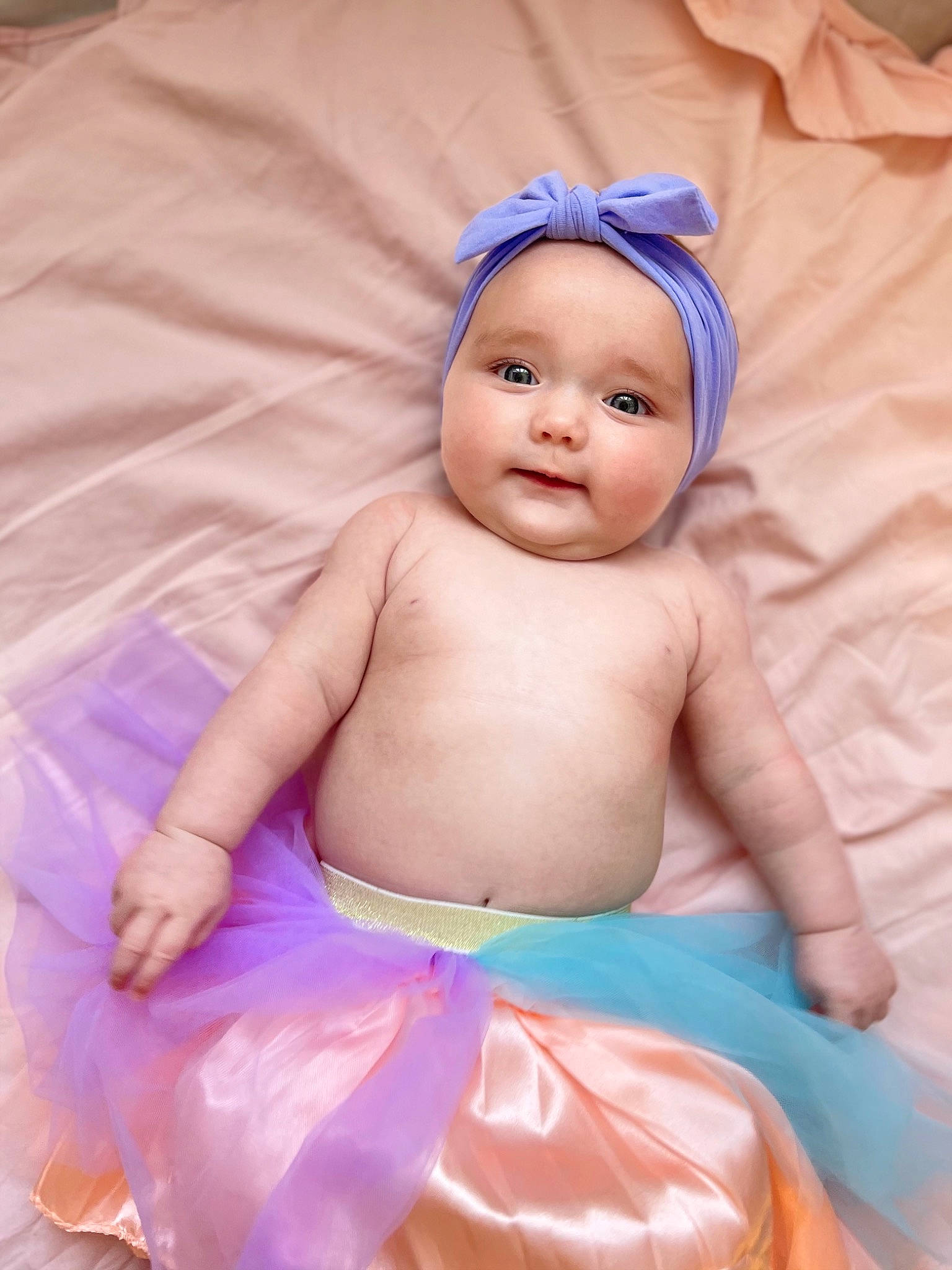 Tilly is registered to the contest to win money with this photo: azure, baby, baby_products, baby_toddler_clothing, cap, child, comfort, electric_blue, fun, happy, headwear, linens, magenta, person, pink, product, purple, skin, smile, textile