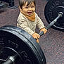 Dario a rejoint le concours — aidez-le/la à gagner de superbes lots ! child, toddler, smiling, barbell, weight_plates, gym, fitness, rubber_floor, baby, portrait, happy, clothing, bib, hands, hair, eyes, equipment, strength, indoor, playful