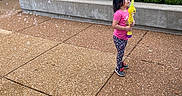 Leianna is registered to the contest to win money with this photo: brick_wall, bubble_sword, bubbles, casual_clothing, child, concrete, daytime, fun, girl, greenery, leggings, outdoor, pink_shirt, play, side_view, sidewalk, sneakers, toy, urban, young