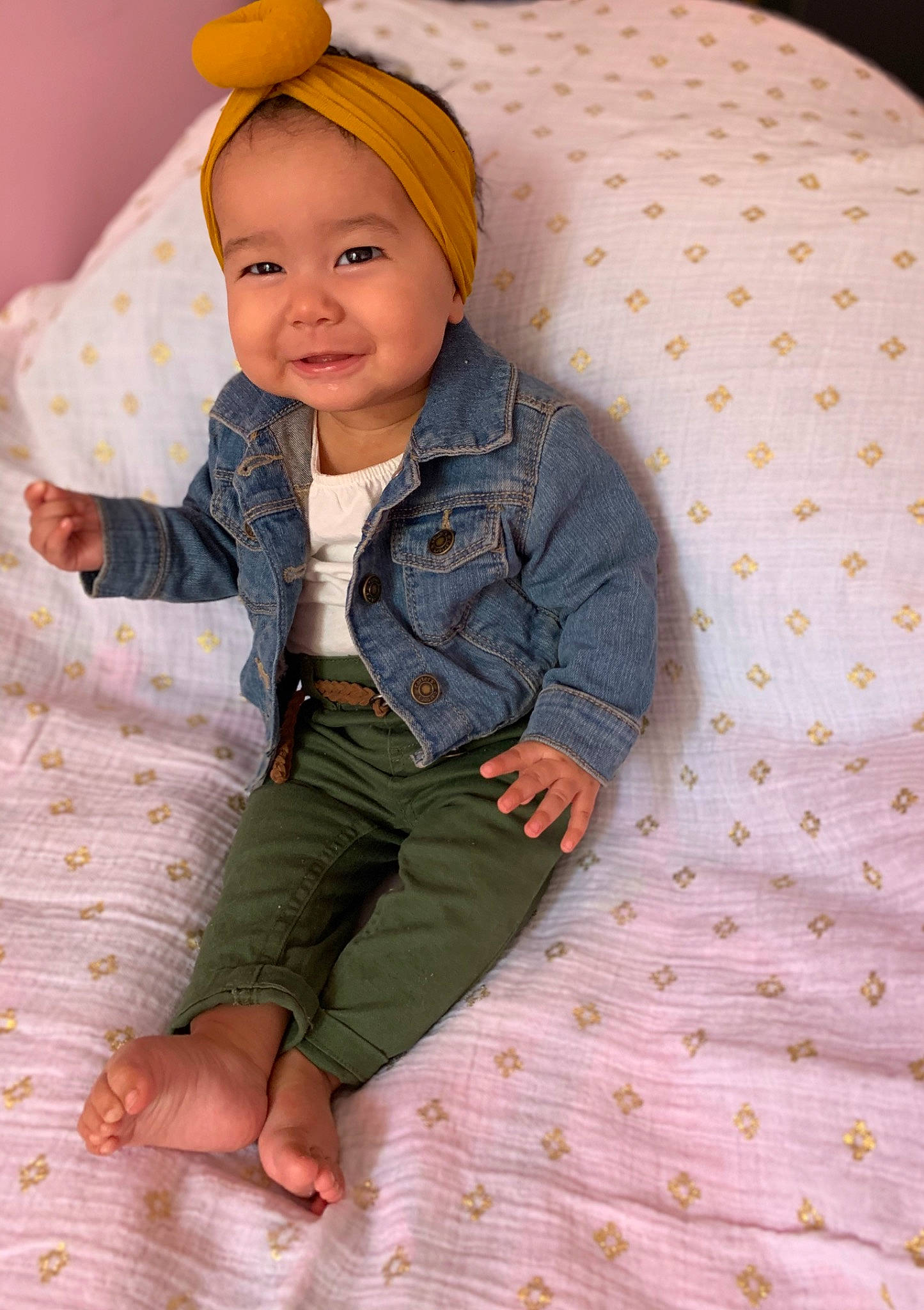 Celine is registered to the contest to win money with this photo: baby, child, child_model, headgear, outerwear, pattern, person, skin, toddler, yellow