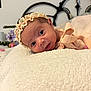 Aurora joined the competition — help win amazing prizes! baby, infant, headband, blanket, bed, dress, bow, face, eyes, portrait, bedroom, decor, floral, soft_texture, candid, lying_down, closeup, cute, child, indoors