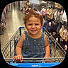 aisle, bras, child, clothing, curly_hair, denim, dress, grinning, hair_bow, happy, indoor, portrait, retail, shopping, shopping_cart, smiling, store, toddler, underwear, walmart