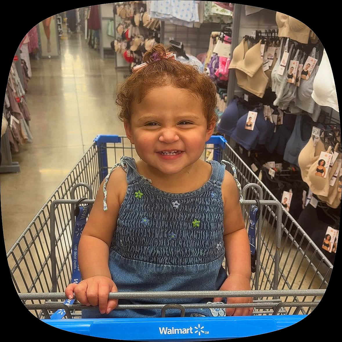 Yessari Salas is registered to the contest to win money with this photo: aisle, bras, child, clothing, curly_hair, denim, dress, grinning, hair_bow, happy, indoor, portrait, retail, shopping, shopping_cart, smiling, store, toddler, underwear, walmart
