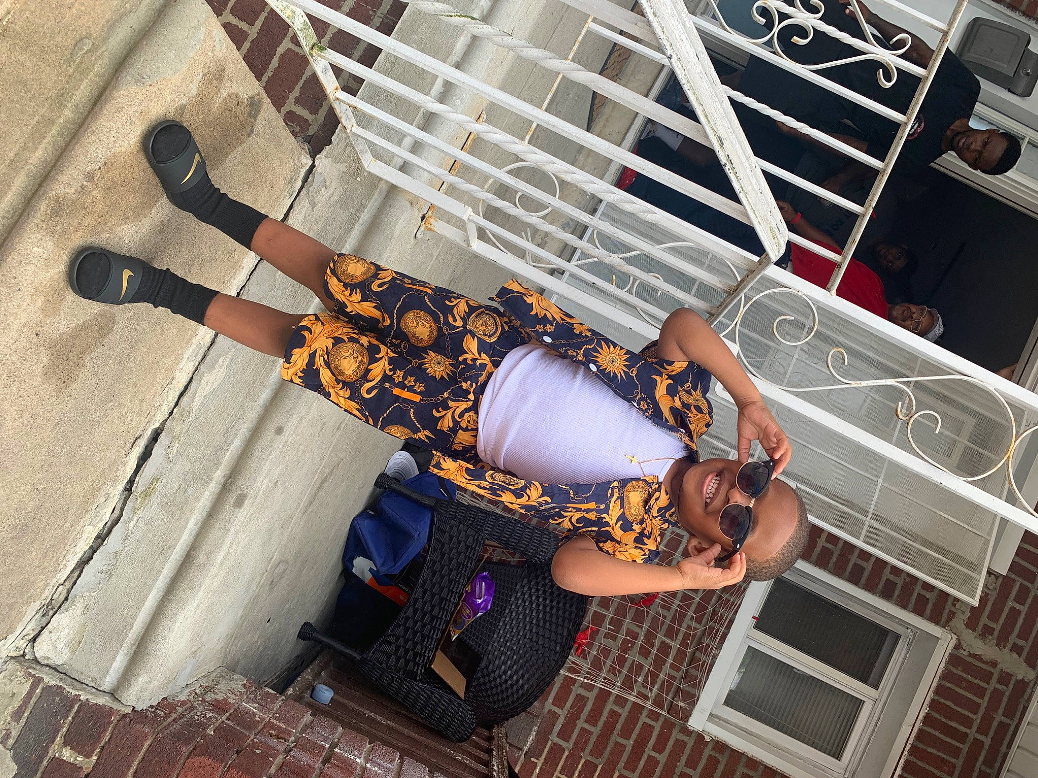 Karter is registered to the contest to win money with this photo: arm, costume, dress, event, eyewear, fashion_accessory, fun, handrail, hat, headwear, human_leg, joy, knee, leg, metal, pattern, person, sandal, stairs, street_fashion