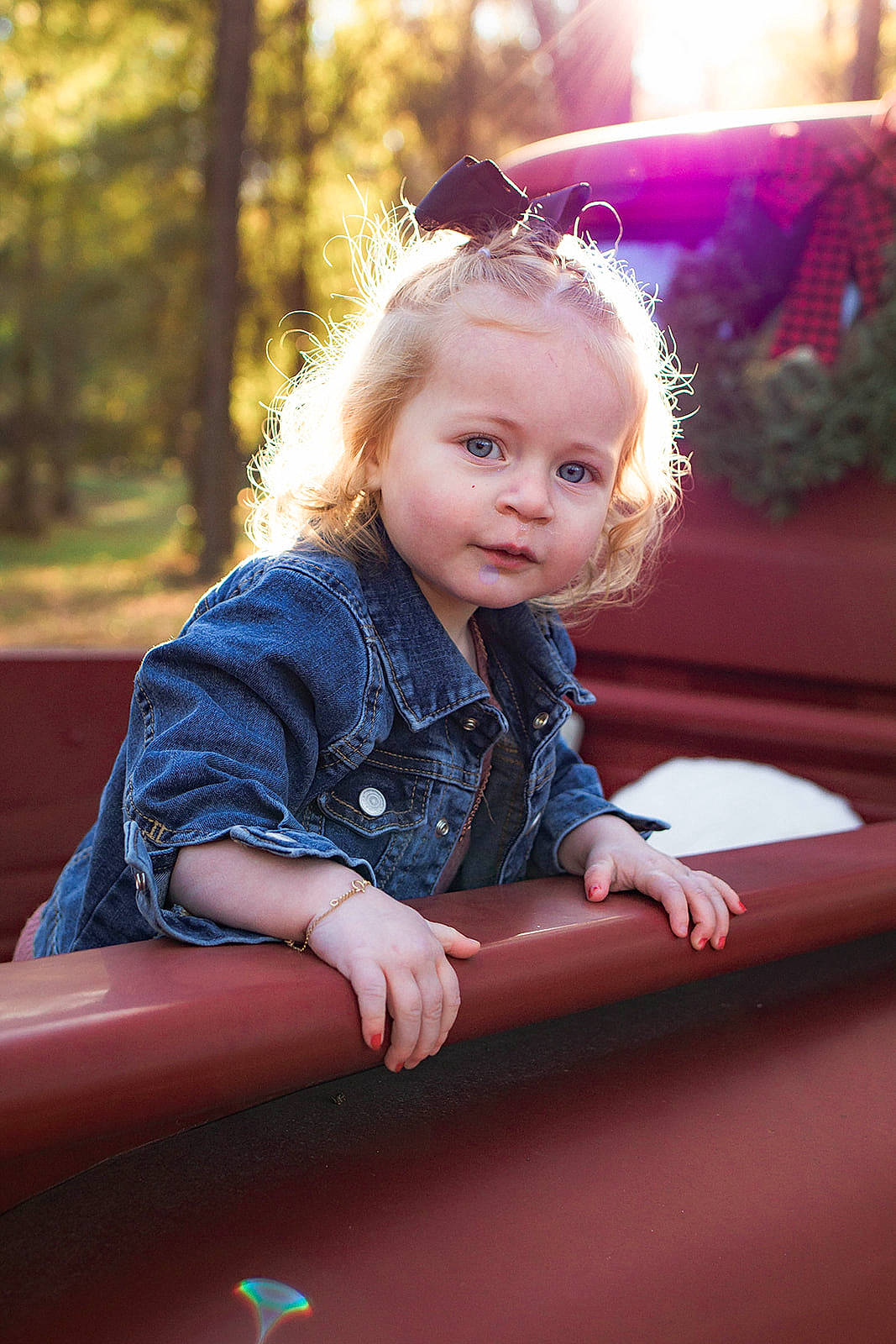 Abby is registered to the contest to win money with this photo: blond, child, electric_blue, eye, flash_photography, fun, grass, happy, head, human_body, leisure, light, person, pink, plant, sitting, skin, tints_and_shades, toddler, tree