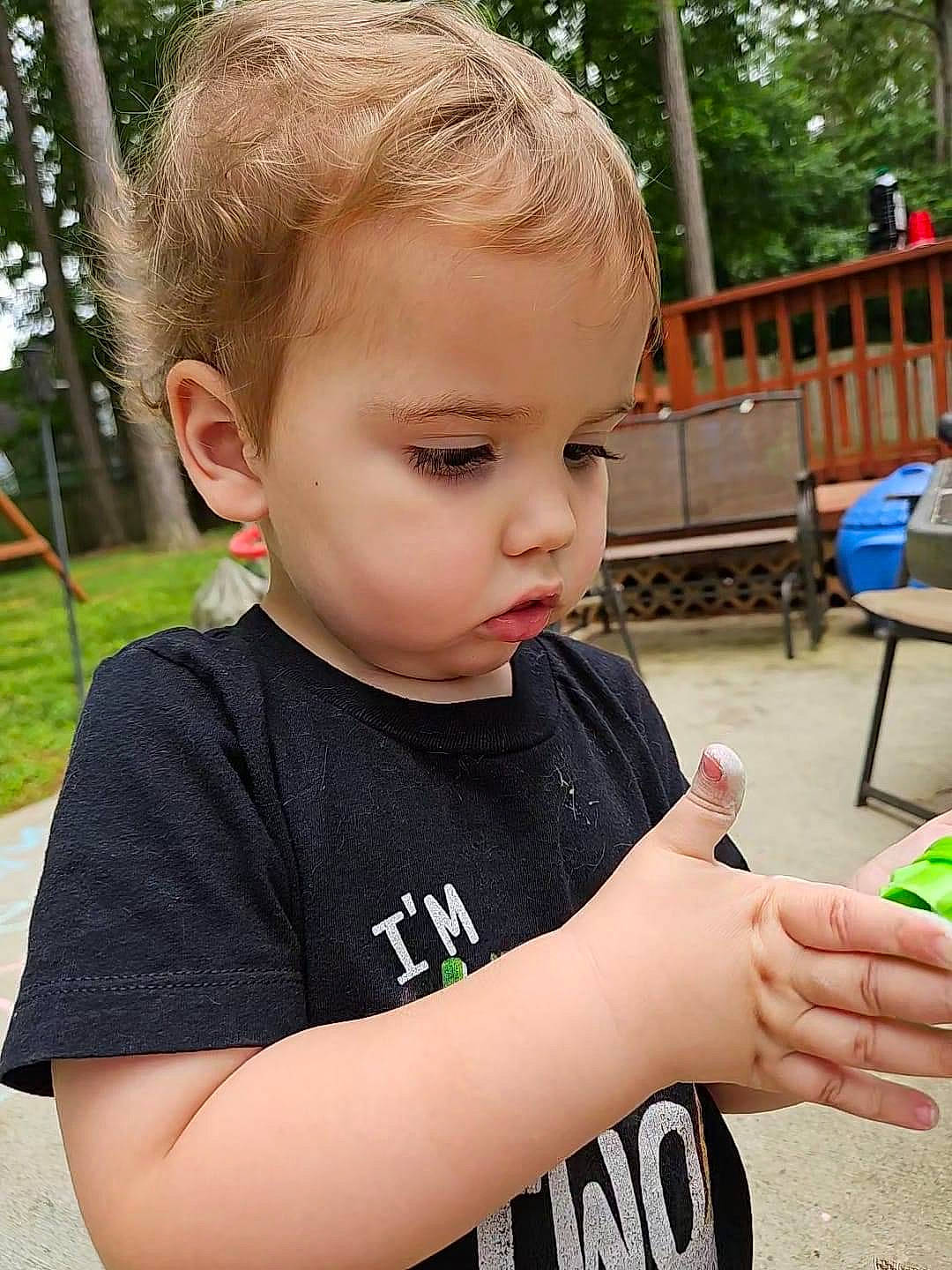 Weston is registered to the contest to win money with this photo: baby, chair, child, fun, grass, hair, happy, leisure, person, plant, play, recreation, sitting, skin, t_shirt, toddler, tree, vacation