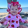 baby, child, swimsuit, sun_hat, strawberry_pattern, pink_clothing, outdoor, lake, tree, summer, cute, portrait, infant, hands, wooden_bench, nature, blue_sky, smile, expression, sitting