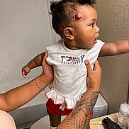 Kehlani joined the competition — help win amazing prizes! toddler, child, person, tattoo, hair_puffs, white_top, red_shorts, bathroom, sink, hairbrush, curious, standing, holding_hands, toilet, wall, countertop, shoe, footwear, skin, indoor