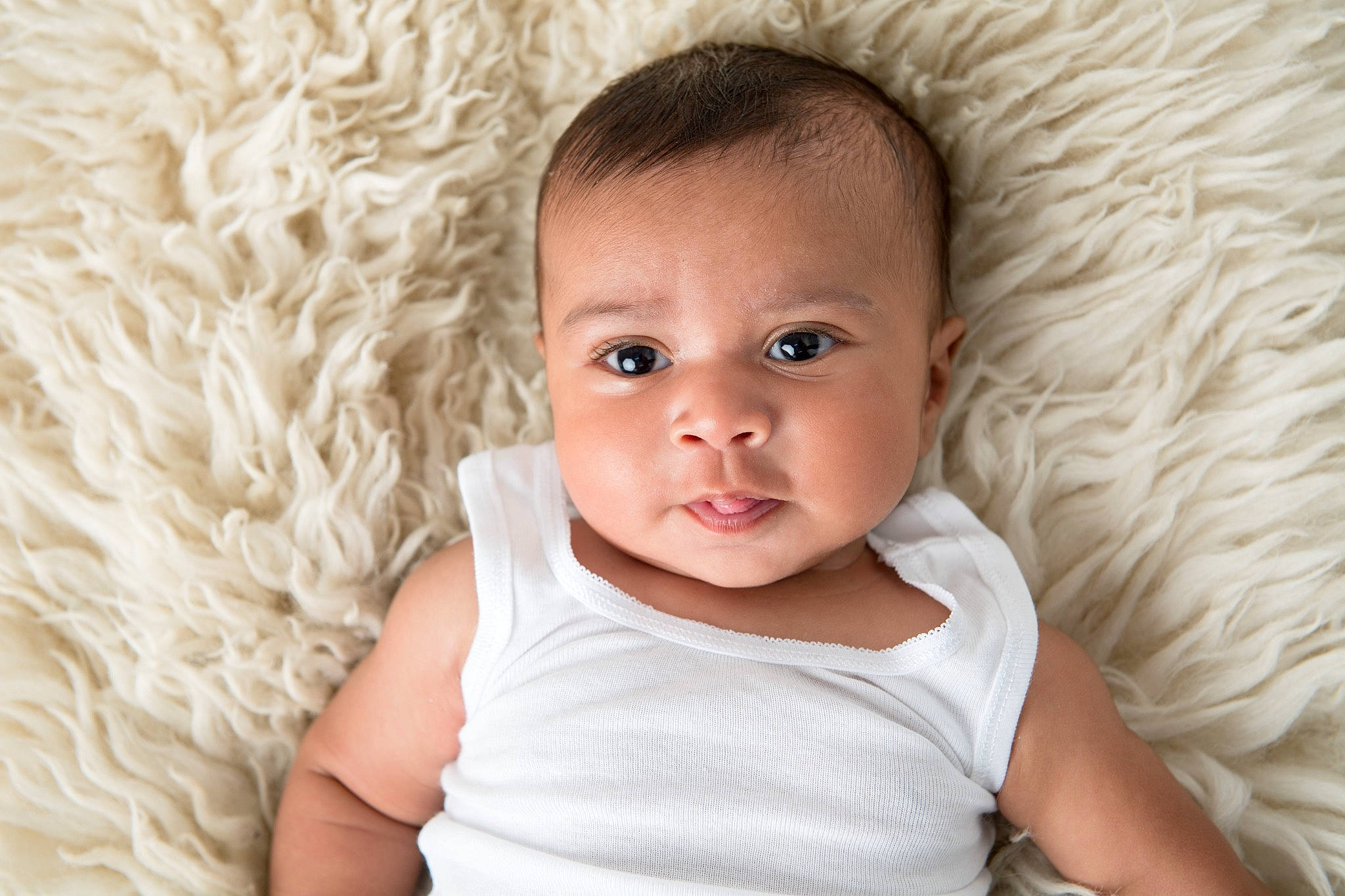 Santiago is registered to the contest to win money with this photo: baby, baby_toddler_clothing, cheek, child, comfort, eye, eyelash, flash_photography, fur, grass, happy, iris, linens, nose, person, sitting, skin, sleeve, smile, toddler