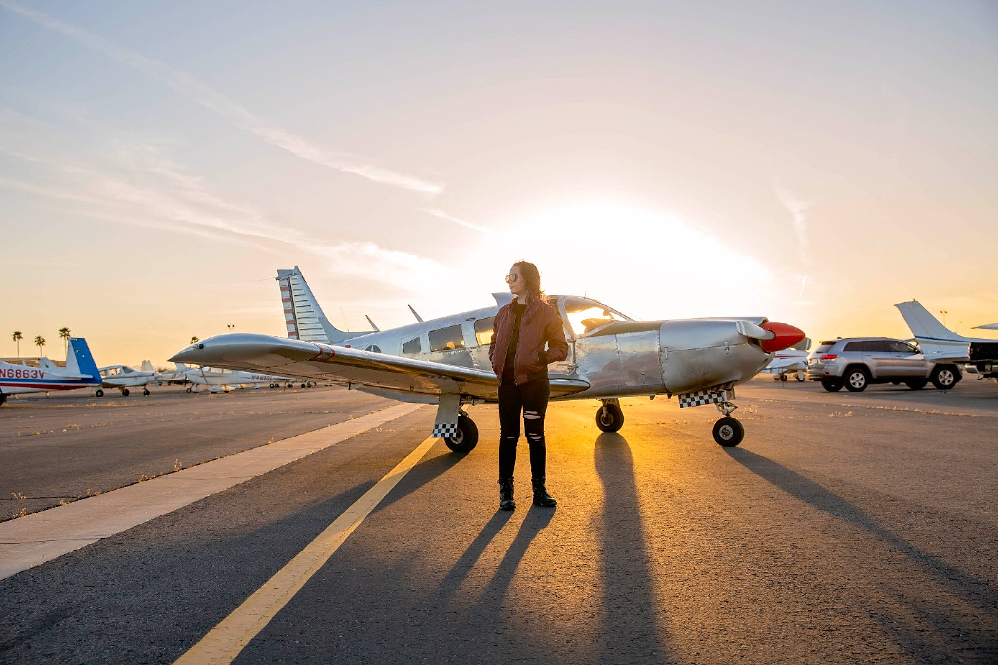 Jayde is registered to the contest to win money with this photo: aerospace_manufacturer, air_travel, aircraft, aircraft_engine, airplane, asphalt, aviation, cloud, flap, military_aircraft, monoplane, person, propeller, runway, sky, tire, travel, vehicle, wheel, wing