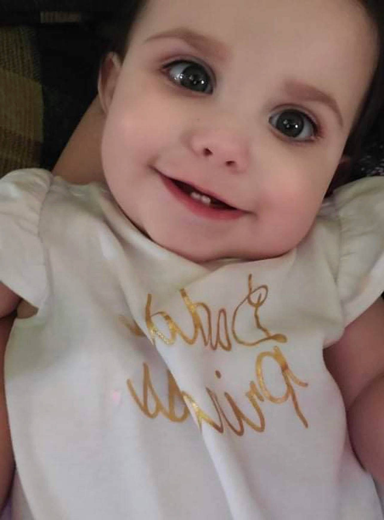 Nora Raine is registered to the contest to win money with this photo: arm, baby, baby_toddler_clothing, cheek, chin, eyebrow, eyelash, finger, flash_photography, forehead, gesture, hand, happy, iris, joy, lip, neck, nose, person, skin