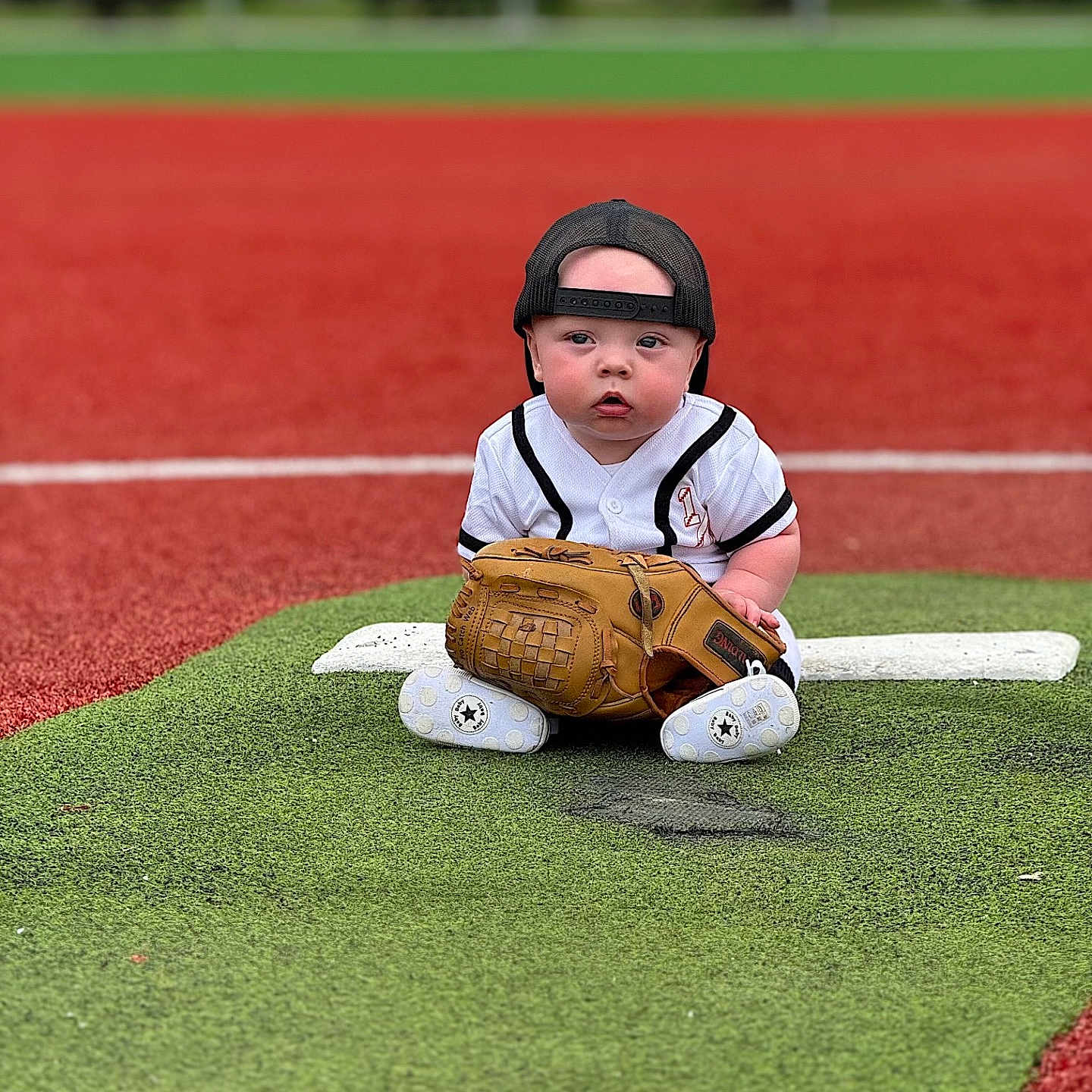 Ryker joined the competition — help win amazing prizes! americanfootball, baby, baseball, baseballglove, cap, clothing, face, field, football, footwear, glove, hat, head, people, person, shoe, sphere, sport, team, teamsport