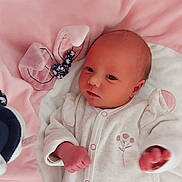 Cléa participe au concours pour gagner de l'argent avec cette photo : newborn, baby, infant, blanket, pink, white, onesie, soft, plush_toy, cute, sleepy, small, cozy, child, portrait, indoor, resting, peaceful, young, clothing