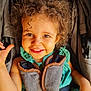 Laïna a rejoint le concours — aidez-le/la à gagner de superbes lots ! baby, baby_carrier, brown_eyes, child, childhood, closeup, curly_hair, cute, daylight, green_clothing, happy, infant, outdoor, person, portrait, seat, seatbelt, smiling, stroller, toddler