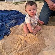 Miles joined the competition — help win amazing prizes! baby, child, sand, outdoor, play, blanket, person, kneeling, clothing, hand, foot, fence, vehicle, road, nature, grass, casual, curious, cute, daytime