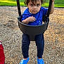 Zyon Levo joined the competition — help win amazing prizes! toddler, child, swing, playground, blue_shirt, blue_shoes, bucket_swing, wood_chips, grass, outdoor, park, person, young_child, curious, hand_on_chest, daylight, casual_clothing, play, fun, happy