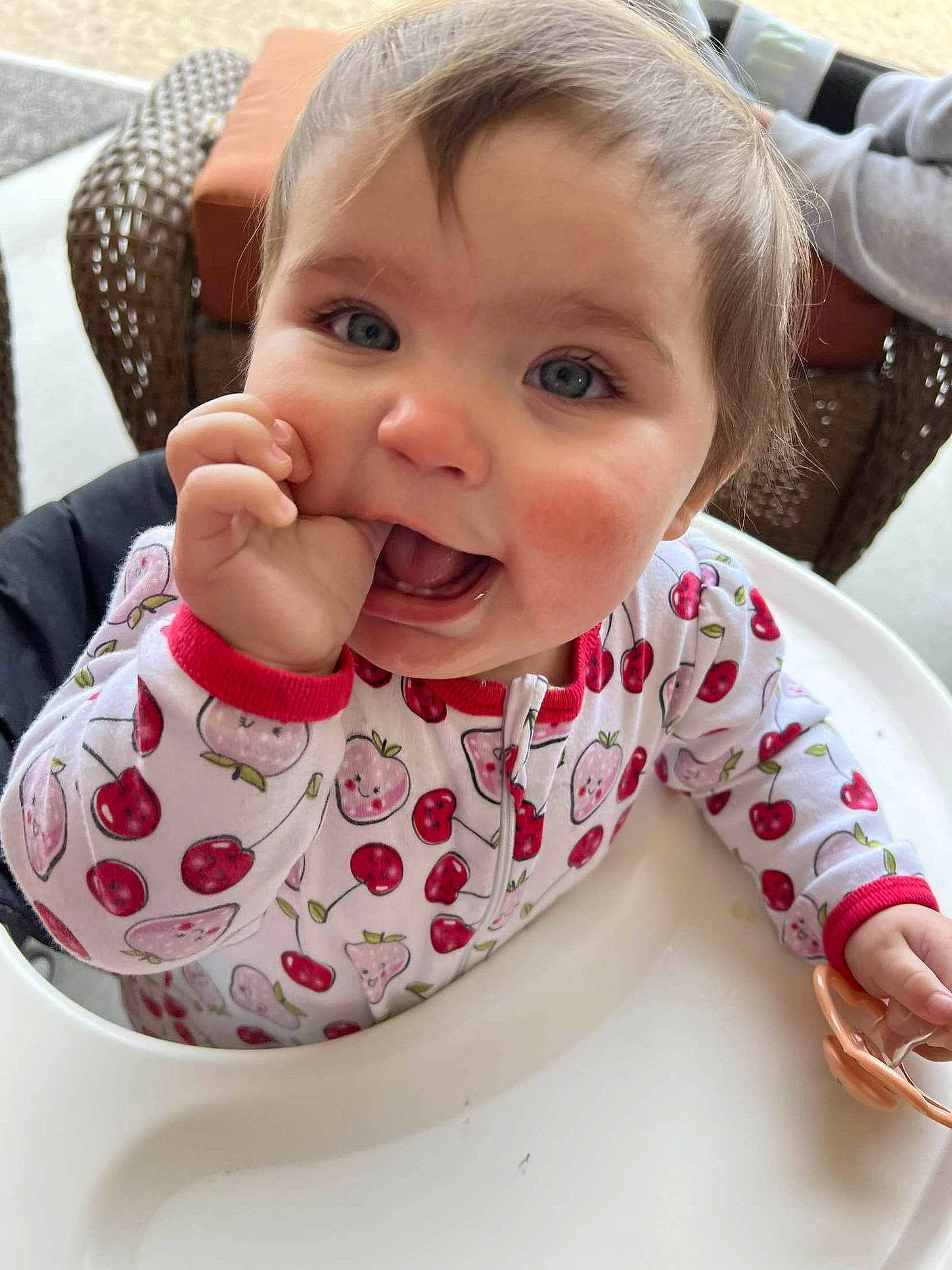 Iris is registered to the contest to win money with this photo: baby, baby_toddler_clothing, bib, cheek, child, drinkware, eye, finger, food_craving, happy, lip, mouth, nose, pattern, person, sitting, skin, sleeve, smile, tableware