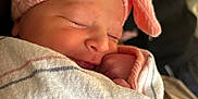 Sophia is registered to the contest to win money with this photo: newborn, baby, sleeping, blanket, pink_bow, headband, closeup, soft_light, cozy, wrapped, infant, peaceful, person, portrait, indoor, cute, human, child, toddler, family