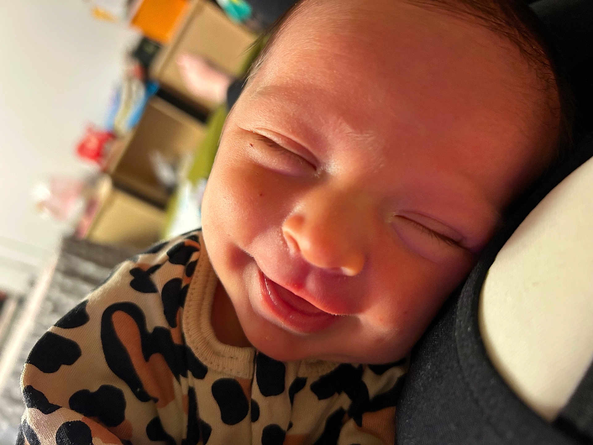 Sophia is registered to the contest to win money with this photo: baby, smile, closeup, infant, face, sleeping, clothing, pattern, spots, cute, joy, resting, cozy, soft_light, portrait, newborn, happy, child, indoor, person