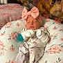 Sophia joined the competition — help win amazing prizes! baby, sleeping, headband, pink_bow, mittens, floral_onesie, cushion, floral_pattern, pacifier, newborn, infant, cute, cozy, indoor, portrait, resting, soft_lighting, child, peaceful, nursery