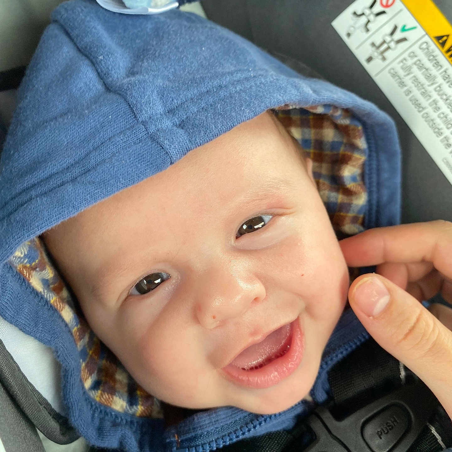 Levon joined the competition — help win amazing prizes! baby, blanket, bonnet, clothing, coat, face, happy, hat, head, hood, hoodie, jacket, knitwear, pants, person, photography, portrait, smile, sweater, sweatshirt