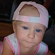 Emery is registered to the contest to win money with this photo: toddler, child, face, blue_eyes, cap, pink_cap, pink_clothing, sleeveless_shirt, indoor, closeup, person, curious, baby, headwear, expression, skin, portrait, young_child, human, casual