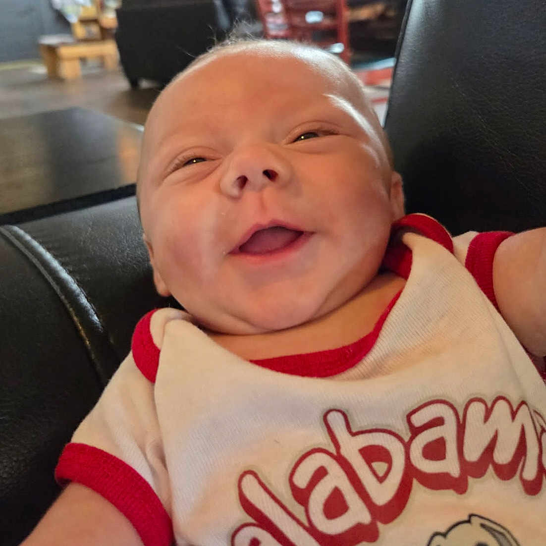 Miles Lee joined the competition — help win amazing prizes! alabama, baby, casual, child, closeup, clothing, cute, face, furniture, happy, head, home, indoor, infant, leather_chair, onesie, person, red_trim, relaxing, smiling