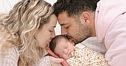 Essil participe au concours pour gagner de l'argent avec cette photo : baby, newborn, family, mother, father, kiss, love, sleeping, closeup, portrait, tender, affection, parent, child, cute, indoor, soft_lighting, onesie, peaceful, blond_hair