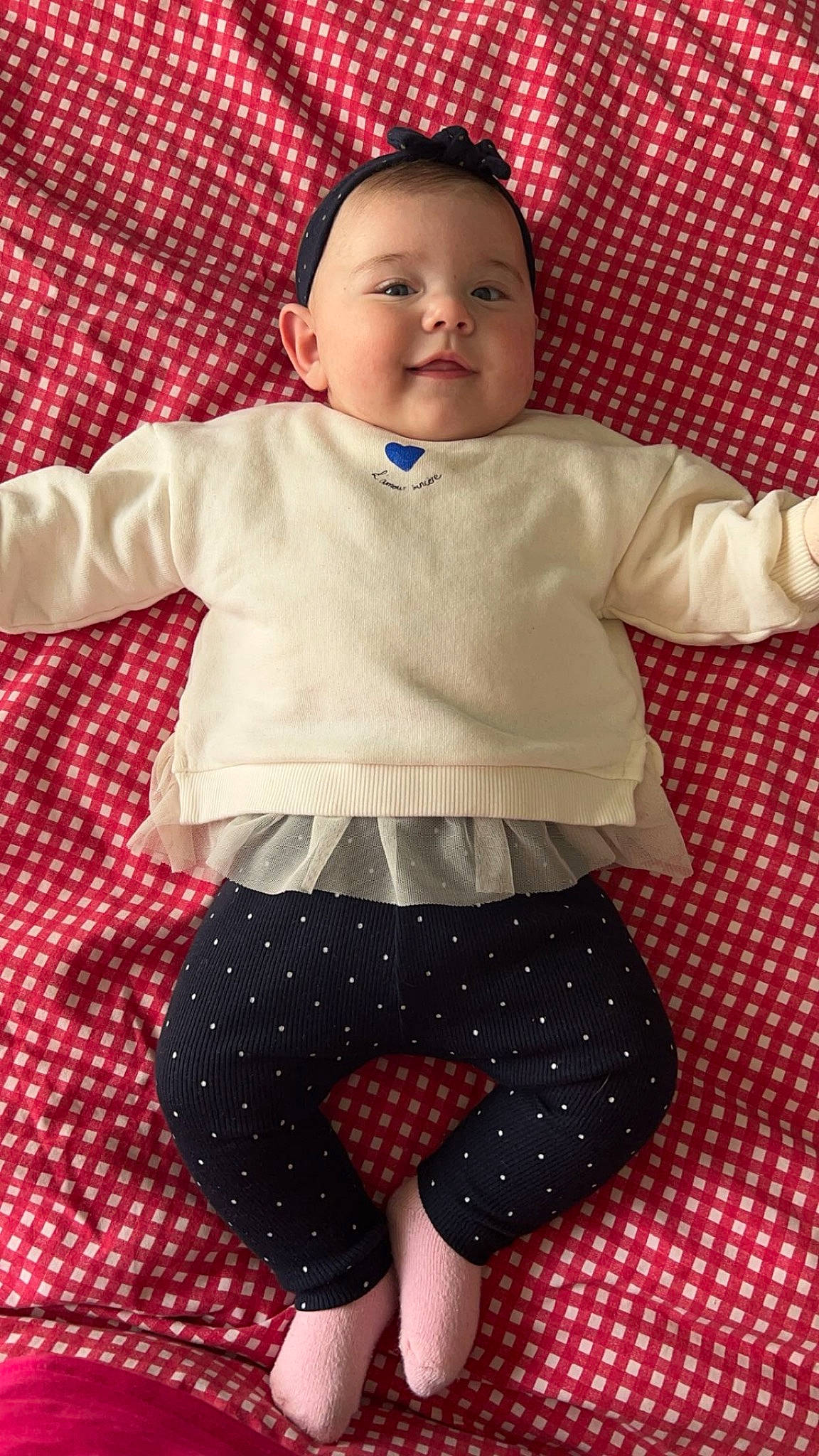 Emna participe au concours pour gagner de l'argent avec cette photo : baby, baby_toddler_clothing, child, collar, face, fun, happy, human_body, linens, magenta, pattern, person, plaid, shorts, sleeve, smile, t_shirt, textile, thigh, toddler
