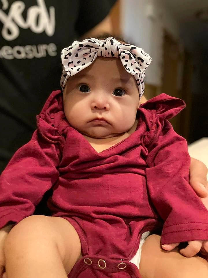 Kylie is registered to the contest to win money with this photo: baby, baby_toddler_clothing, beanie, cap, cheek, child, eyebrow, fashion_accessory, fun, fur, hair_accessory, happy, headwear, knit_cap, magenta, mammal, person, pink, sitting, skin