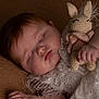 adorable, baby, bunny, child, closeup, cozy, crocheted_toy, cute, drool, fabric, face, hand, infant, lace_dress, peaceful, portrait, resting, sleeping, soft_lighting, texture