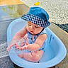 baby, blue_hat, child, cute, fun, gravel, hat, outdoor, pavement, playing, romper, sitting, splashing, summer, sunlight, sunny, toddler, tub, water, water_play
