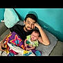 baby, beard, blanket, casual, colorful, comfort, couch, family, father_and_child, green_shirt, home, indoor, man, pillow, portrait, relaxing, resting, smile, star_pattern, toddler