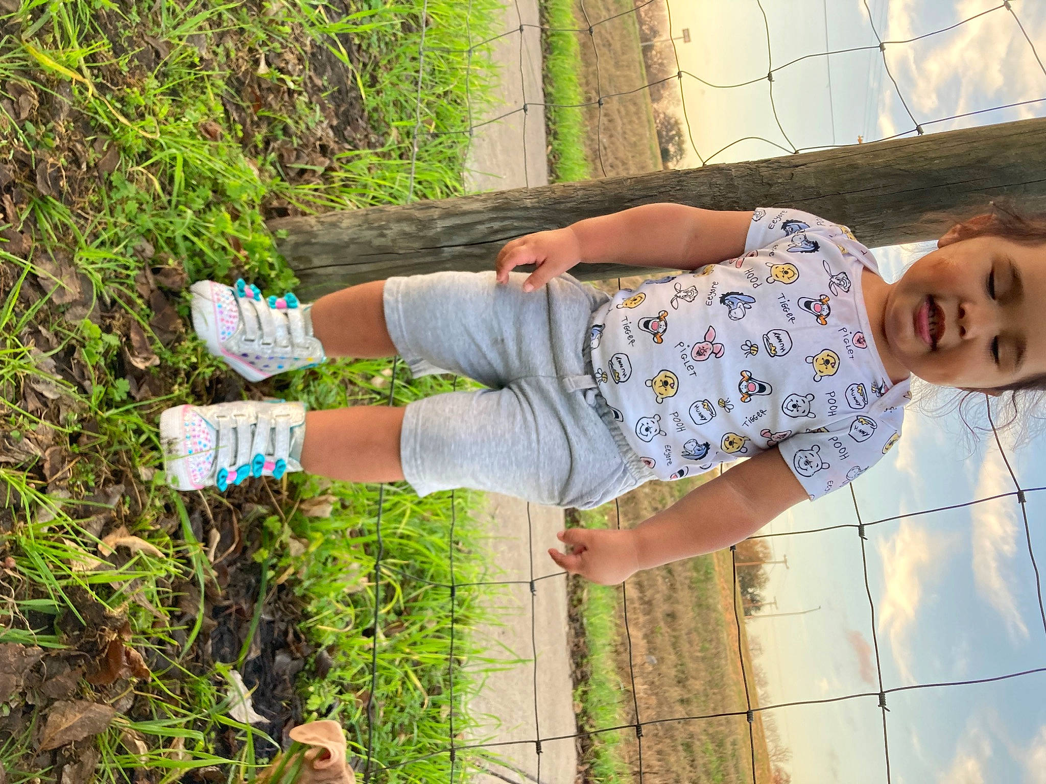 Angelina joined the competition — help win amazing prizes! adaptation, child, elbow, fence, foot, fun, grass, happy, headwear, human_leg, knee, leg, leisure, pattern, people_in_nature, person, plant, soil, t_shirt, thigh