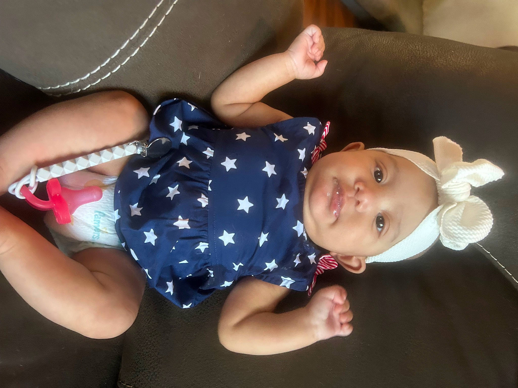 Jenavie is registered to the contest to win money with this photo: arm, baby, baby_products, baby_toddler_clothing, child, elbow, electric_blue, eye, fashion_accessory, finger, gesture, hand, happy, hat, pattern, person, sleeve, smile, textile, thumb