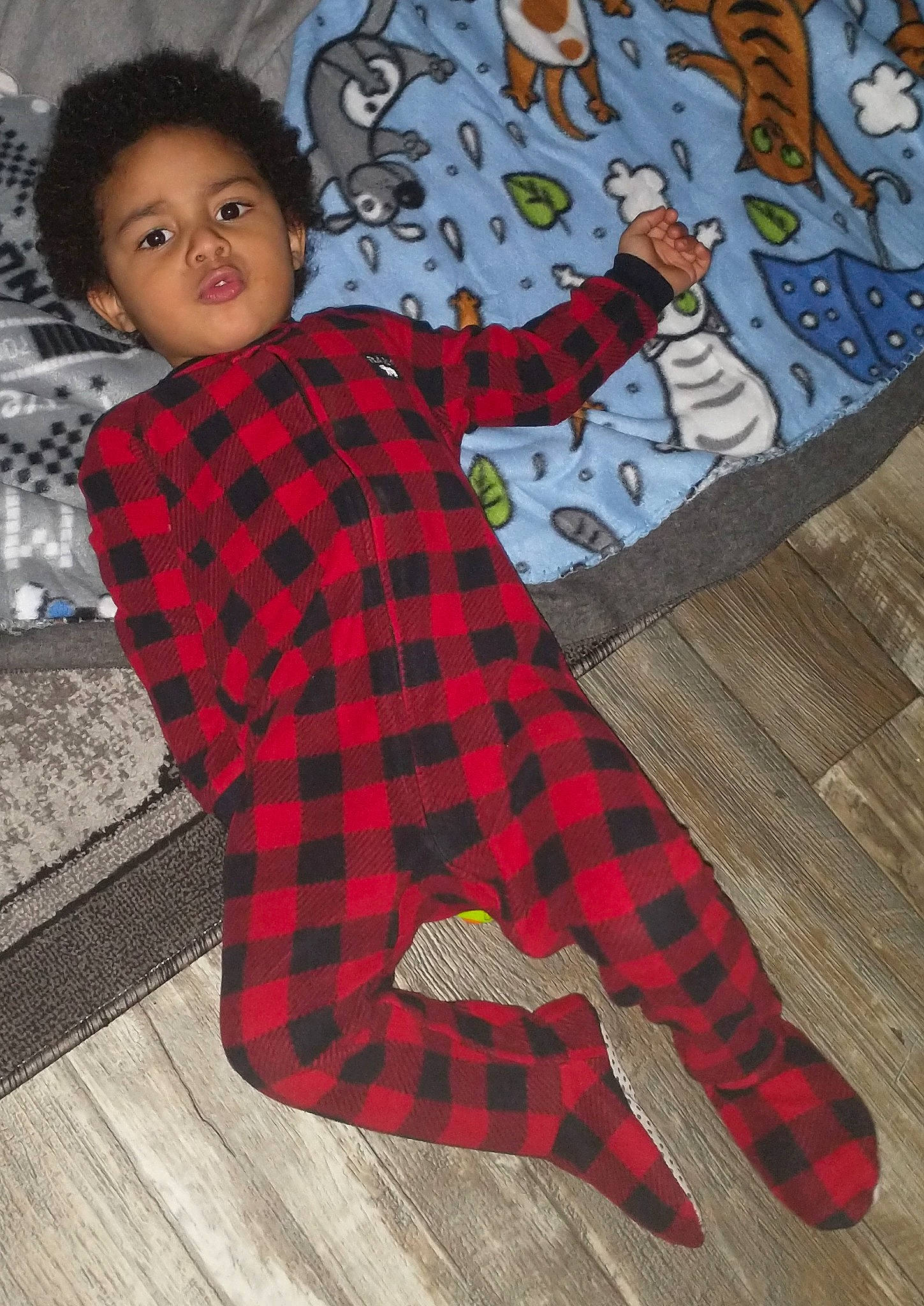 Gregory joined the competition — help win amazing prizes! baby_toddler_clothing, child, dress, face, floor, flooring, head, linens, pattern, person, plaid, sitting, sleeve, sock, spider_man, t_shirt, tartan, textile, thigh, toddler