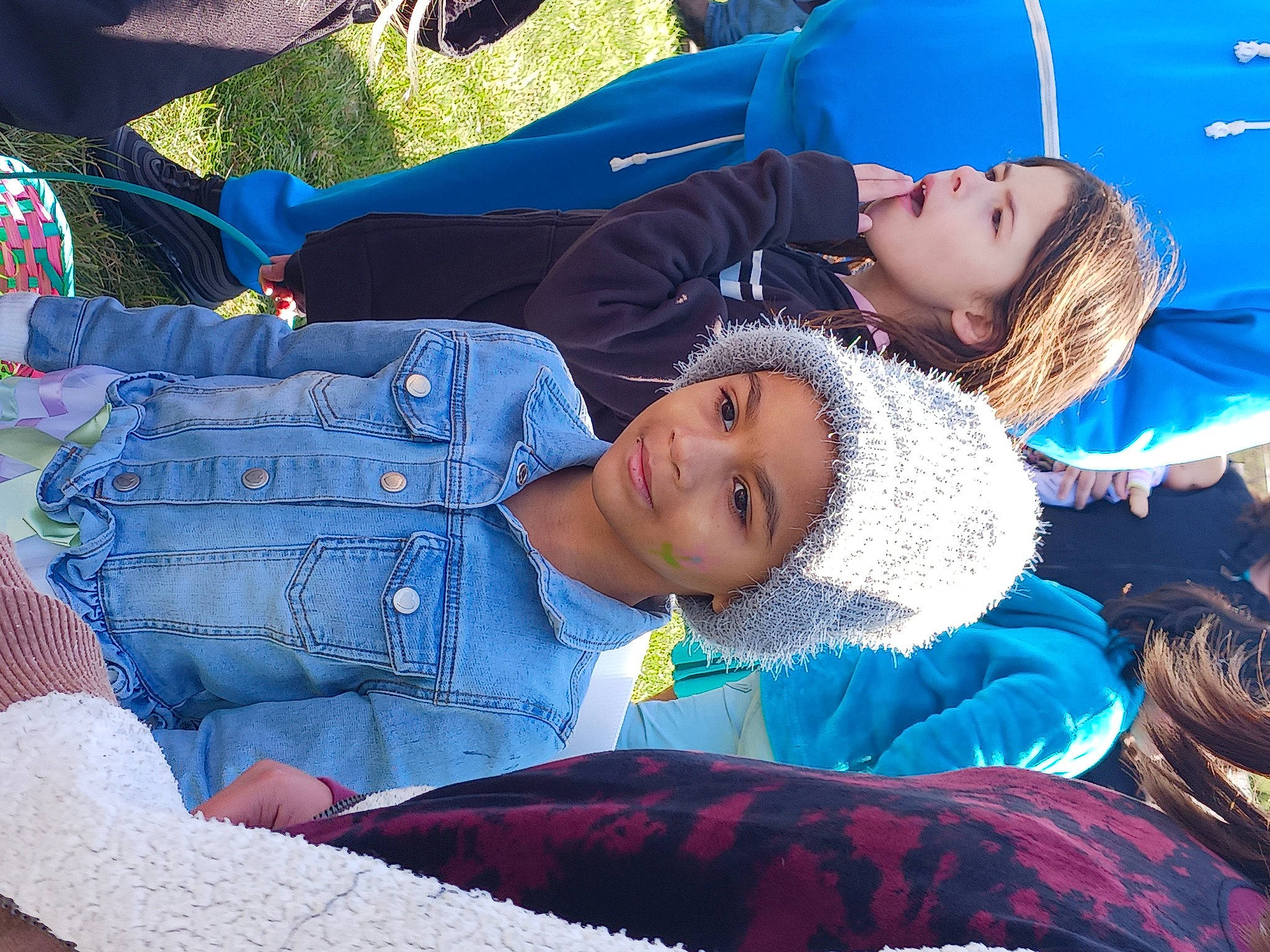 Serenity is registered to the contest to win money with this photo: blue, child, comfort, denim, electric_blue, event, fashion, fun, grass, happy, headwear, jeans, joy, leisure, pattern, person, plant, recreation, red, smile