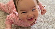 Keanna joined the competition — help win amazing prizes! baby, child, smiling, pink_pajamas, carpet, indoor, floor, hair, happy, crawling, person, infant, cute, home, playful, toddler, expression, fun, young, room