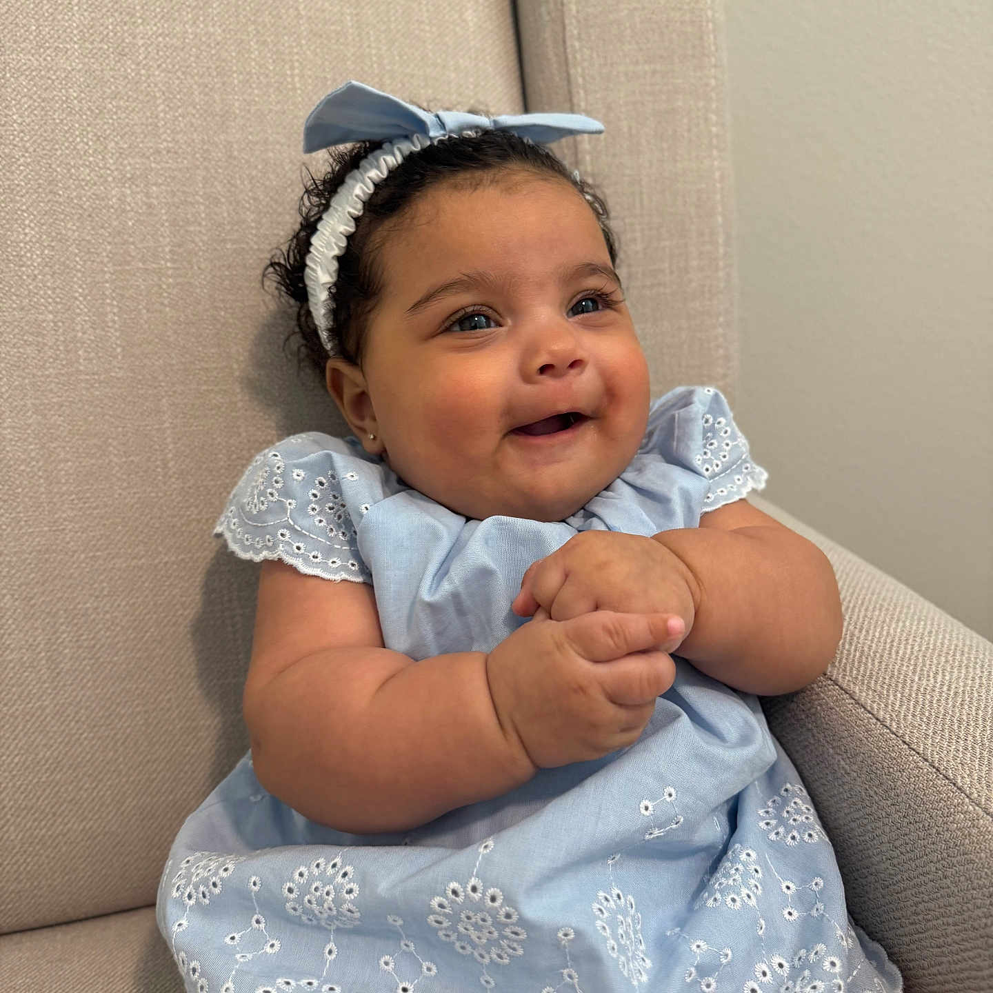 Aisha joined the competition — help win amazing prizes! accessories, baby, bodypart, bonnet, clothing, couch, dress, face, finger, furniture, hand, happy, hat, head, headband, newborn, person, photography, portrait, sitting