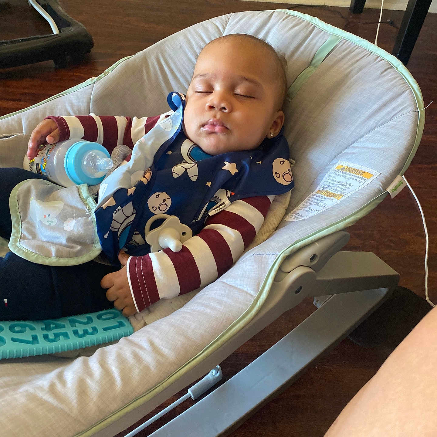 Davontae joined the competition — help win amazing prizes! baby, baby_bottle, bib, bouncer, child, earrings, face, hand, hardwood_floor, home_interior, infant, nap_time, onesie, pacifier, relaxing, seat, sleeping, striped_sleeves, toy, wood_floor