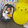 baby, bunny, car_seat, carpet, celebration, child, colorful, cute, decorations, easter, floor, holiday, indoor, infant, inflatable, pattern, playful, smiling, toy, yellow